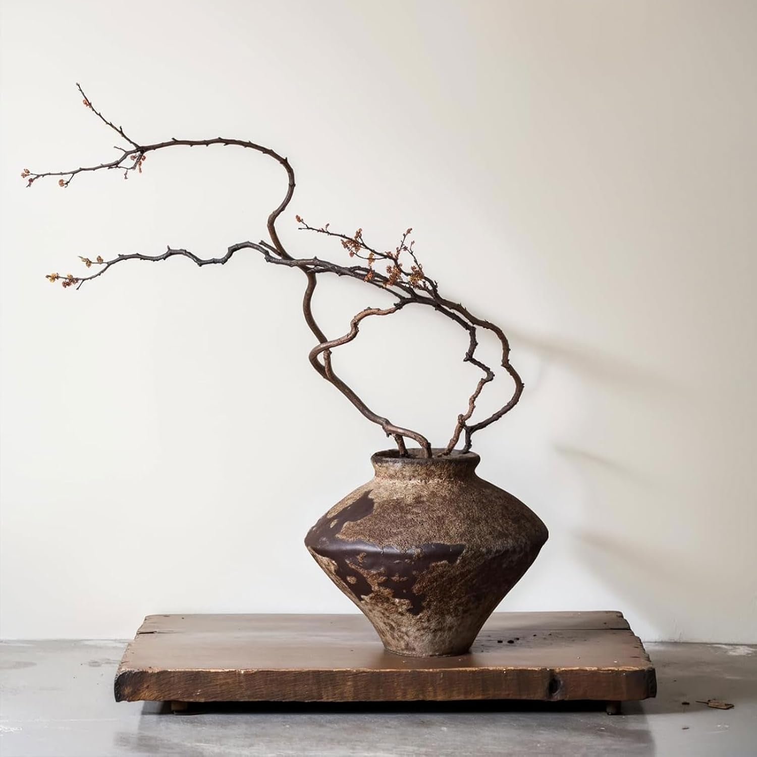 rust — textured rustic pottery vase on a warm shelf
